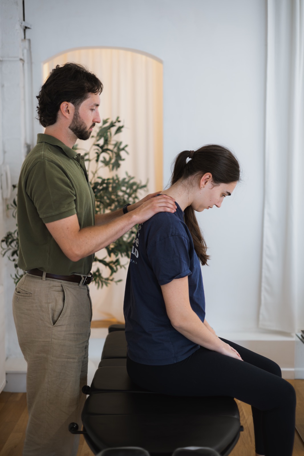 Tom checking a patient's posture in the treatment room